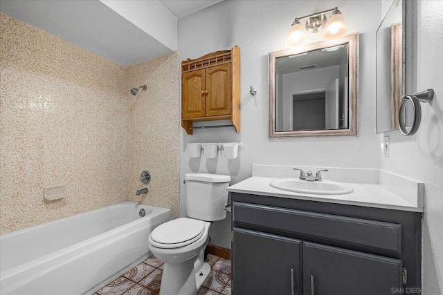 full bathroom with vanity, tiled shower / bath, and toilet