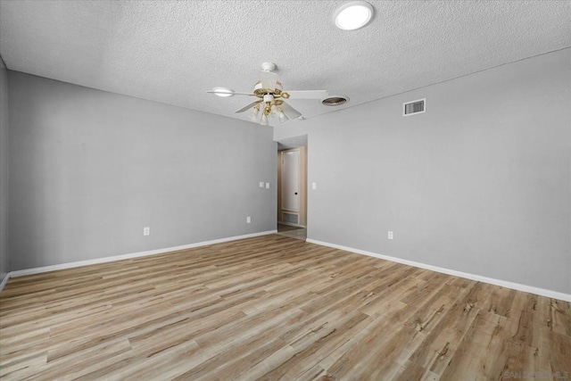 empty room featuring ceiling fan, a textured ceiling, and light wood-type flooring