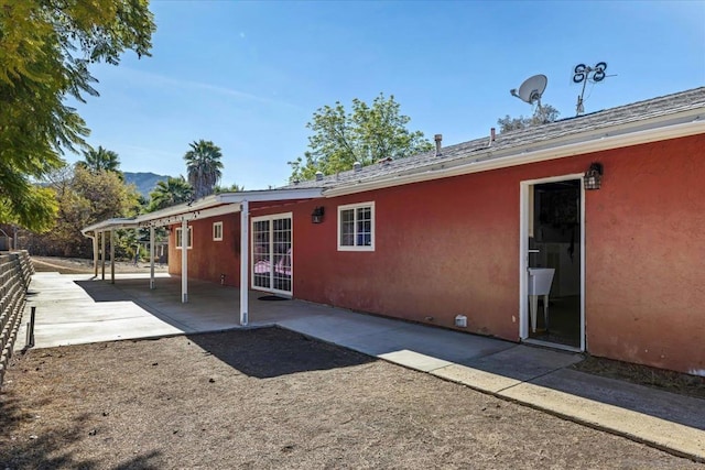 back of property with a patio