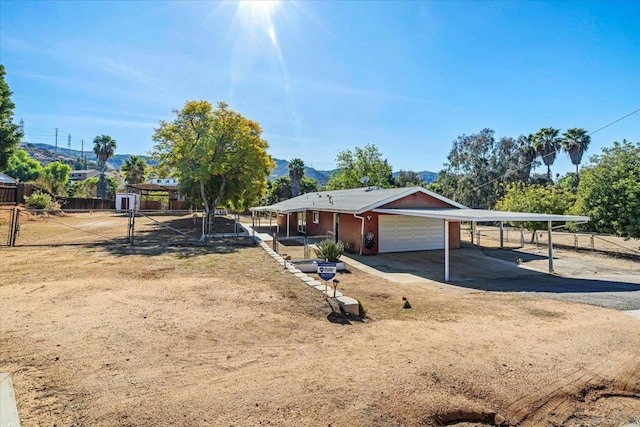 view of front of property featuring a garage and a carport