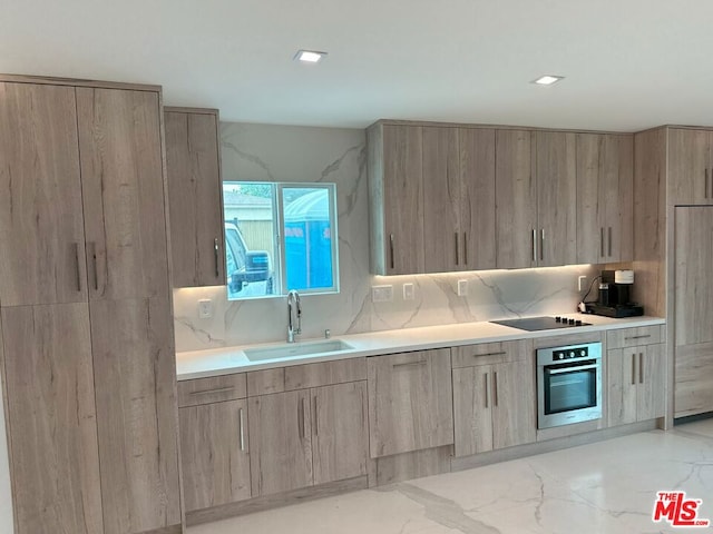 kitchen featuring light brown cabinetry, tasteful backsplash, sink, black electric stovetop, and stainless steel oven