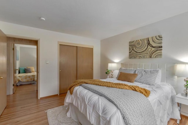 bedroom featuring light wood-type flooring and a closet