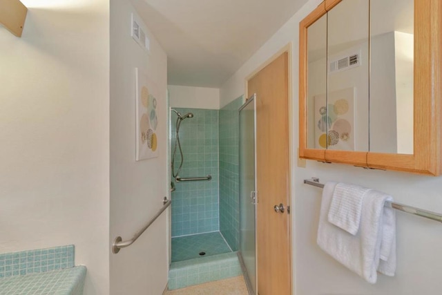 bathroom with tiled shower