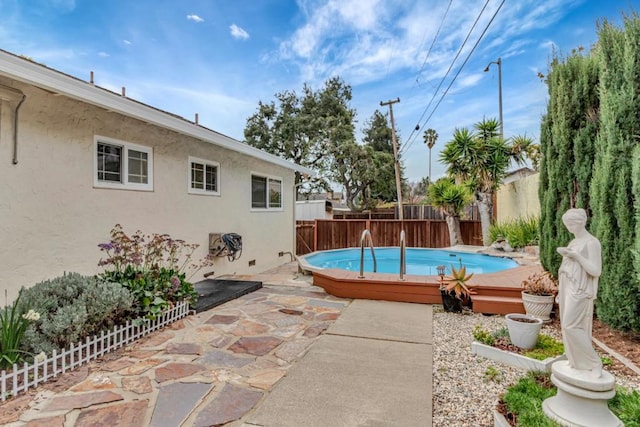 view of pool featuring a patio and a deck