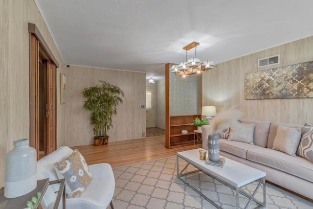 living room with an inviting chandelier and light hardwood / wood-style floors