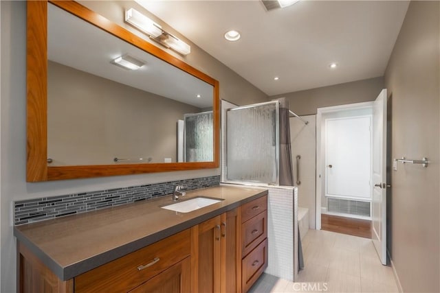 bathroom with tasteful backsplash, vanity, and a shower