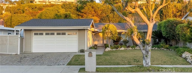 ranch-style home with a garage and a front yard