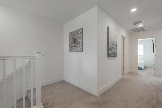 hall featuring light colored carpet