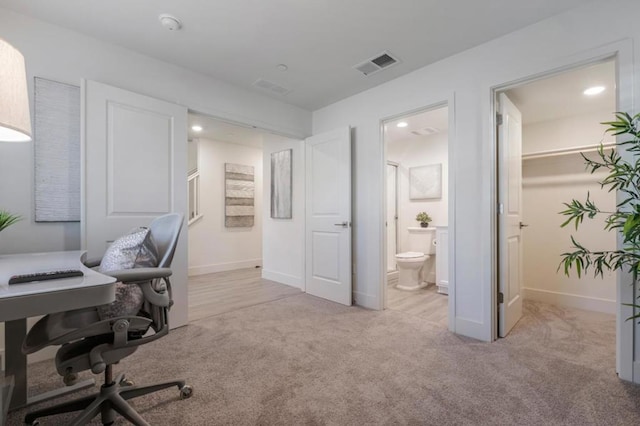 office area featuring light colored carpet