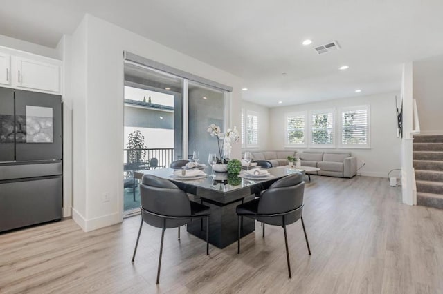 dining space with light hardwood / wood-style flooring