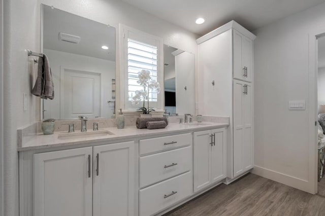 bathroom with vanity and hardwood / wood-style floors