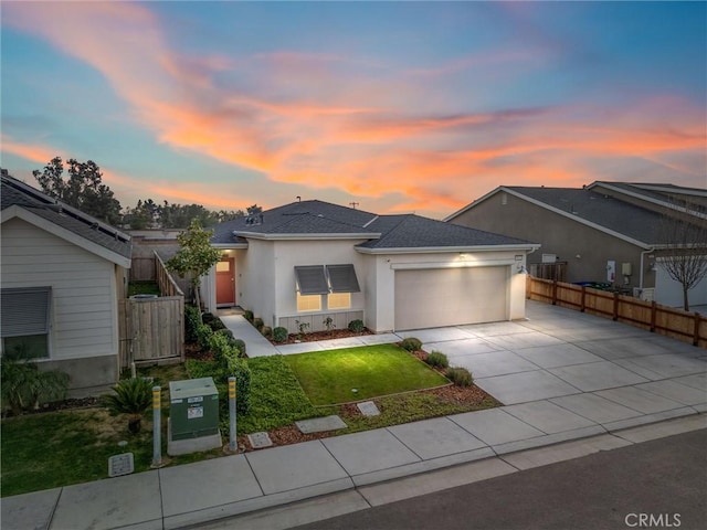 view of front of home with a garage and a yard