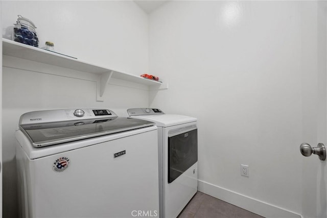 laundry area featuring tile patterned floors and separate washer and dryer