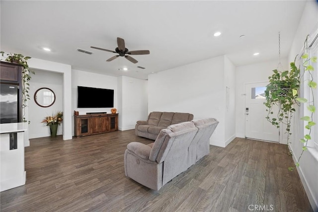 living room with ceiling fan and dark hardwood / wood-style flooring