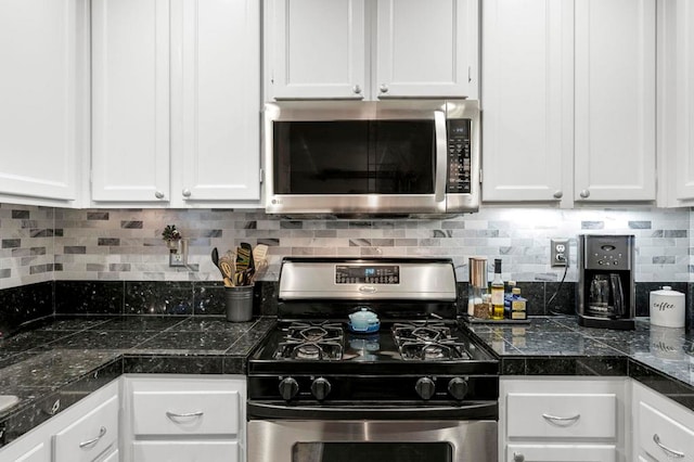 kitchen with white cabinetry, appliances with stainless steel finishes, and backsplash