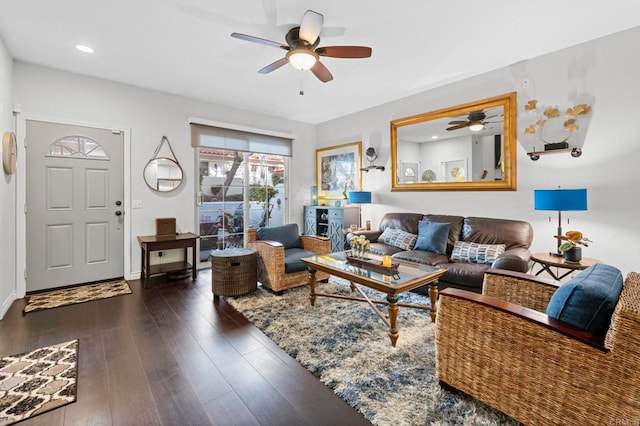 living room with ceiling fan and dark hardwood / wood-style floors