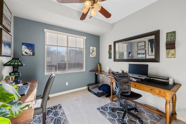 carpeted office space featuring ceiling fan