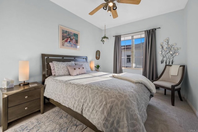 carpeted bedroom featuring ceiling fan and vaulted ceiling