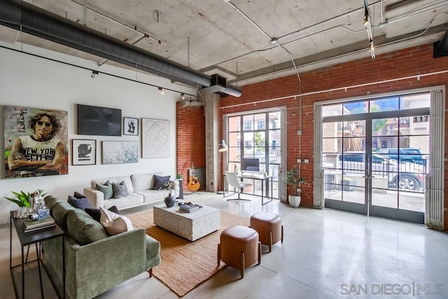 living room with brick wall and concrete floors