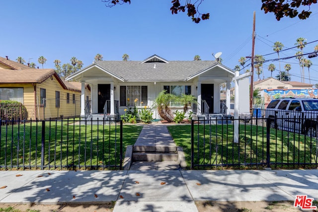 bungalow-style home with a front yard