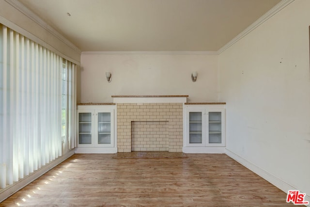 unfurnished living room with ornamental molding and light hardwood / wood-style floors