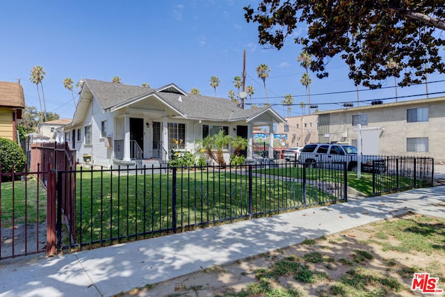 bungalow-style house featuring a front lawn