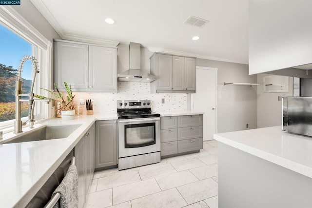 kitchen featuring stainless steel electric range oven, sink, gray cabinetry, and wall chimney exhaust hood