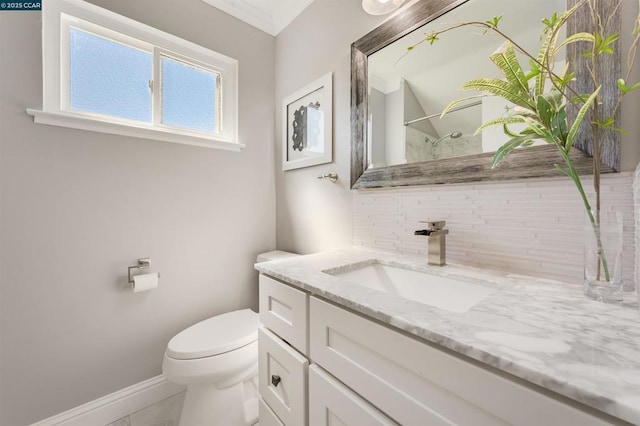 bathroom featuring vanity, backsplash, and toilet