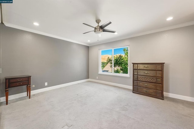 unfurnished bedroom with crown molding, light colored carpet, and ceiling fan