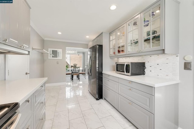 kitchen with tasteful backsplash, stainless steel appliances, and crown molding