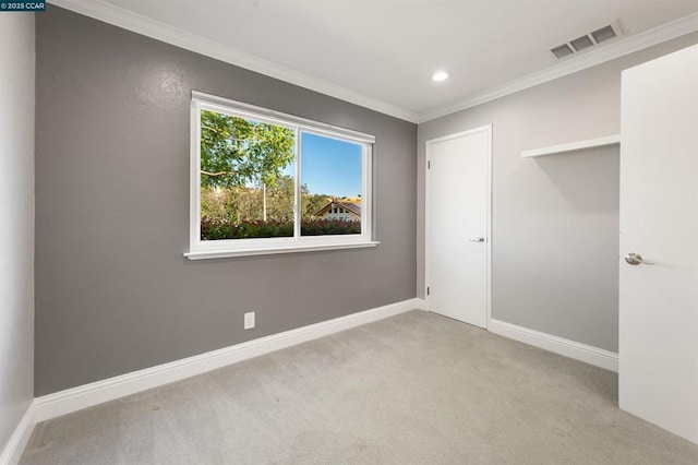 carpeted empty room with crown molding