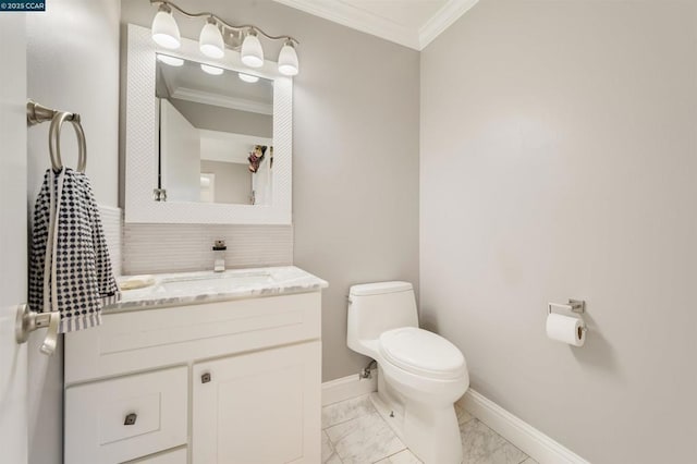 bathroom with vanity, crown molding, and toilet