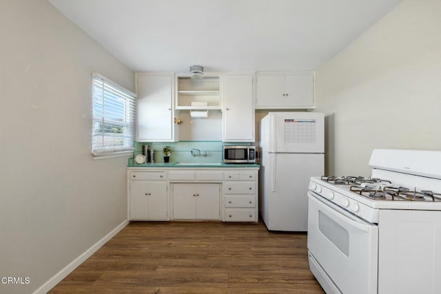 kitchen with white cabinetry, white appliances, and dark hardwood / wood-style flooring