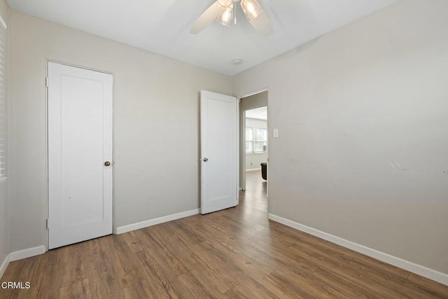 unfurnished bedroom with hardwood / wood-style floors and ceiling fan