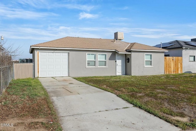 ranch-style home featuring a garage and a front lawn