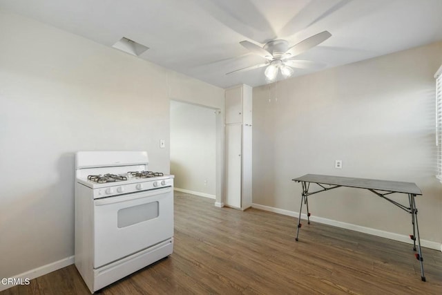 kitchen with ceiling fan, white gas range, and dark hardwood / wood-style flooring