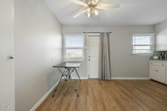 unfurnished dining area featuring hardwood / wood-style flooring and ceiling fan