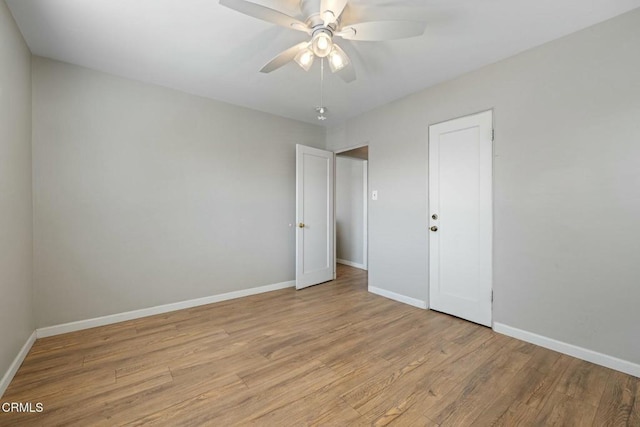 spare room featuring light hardwood / wood-style flooring and ceiling fan