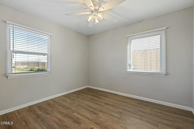 spare room with dark wood-type flooring and ceiling fan