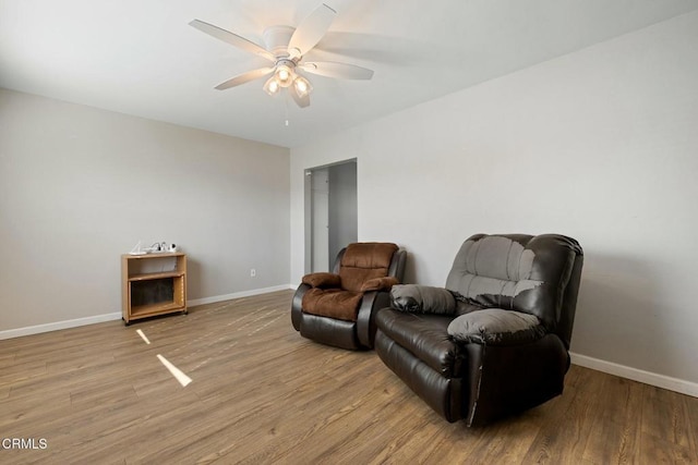 living area featuring ceiling fan and light hardwood / wood-style floors