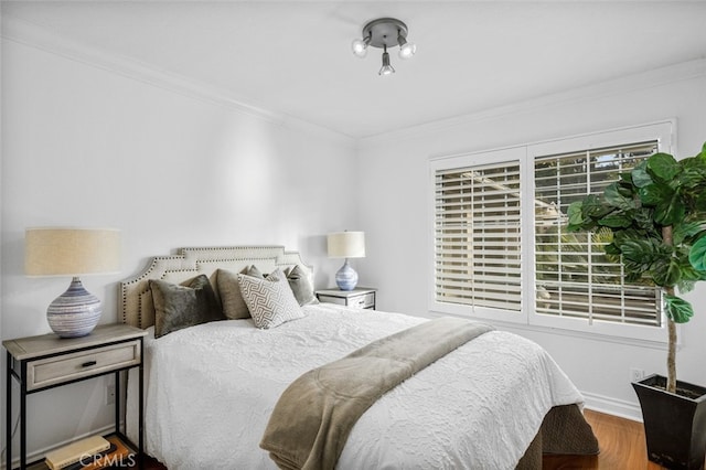 bedroom featuring hardwood / wood-style flooring and crown molding