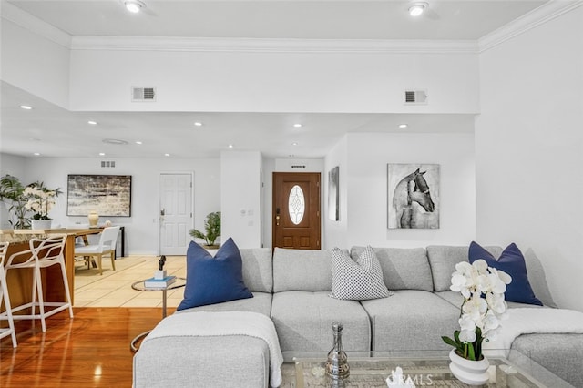 living room featuring ornamental molding and hardwood / wood-style floors