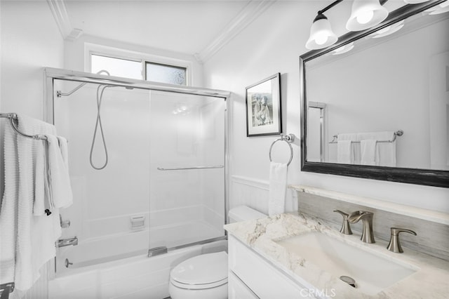 full bathroom with vanity, ornamental molding, enclosed tub / shower combo, and toilet