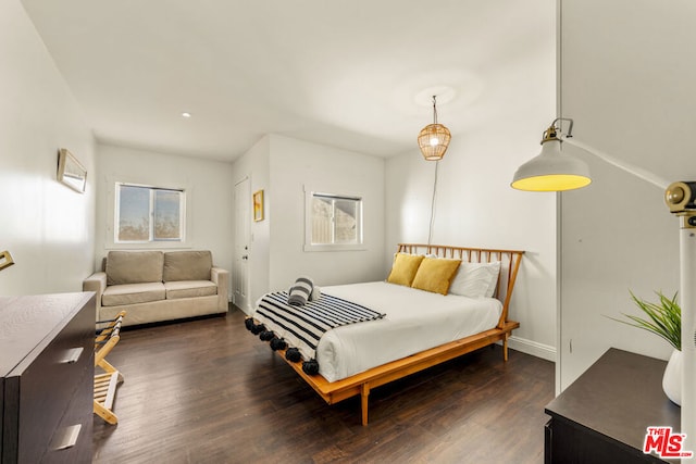 bedroom with dark wood-type flooring