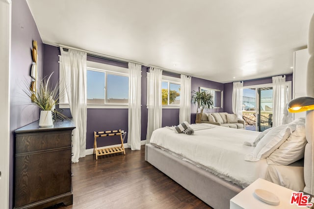 bedroom with dark wood-type flooring