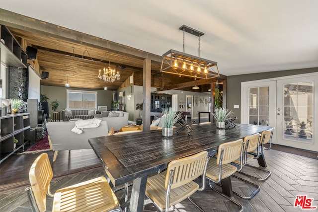 dining area featuring lofted ceiling, an inviting chandelier, dark hardwood / wood-style flooring, wooden ceiling, and french doors