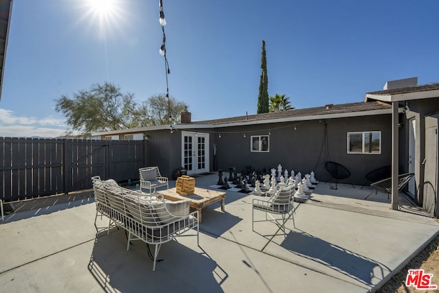 back of property featuring a patio area and french doors