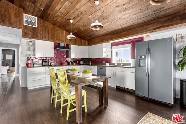 kitchen with white cabinetry, wall chimney exhaust hood, and appliances with stainless steel finishes