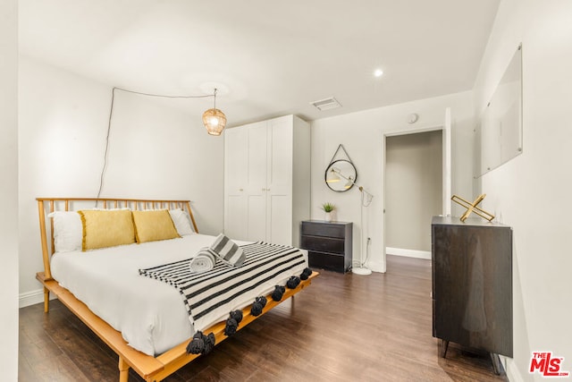 bedroom featuring dark hardwood / wood-style floors