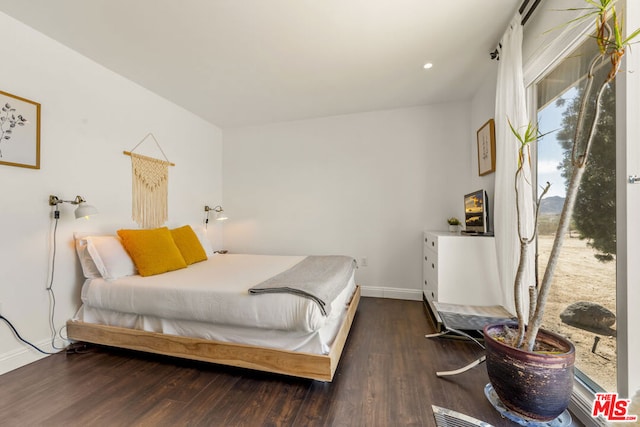 bedroom with dark wood-type flooring